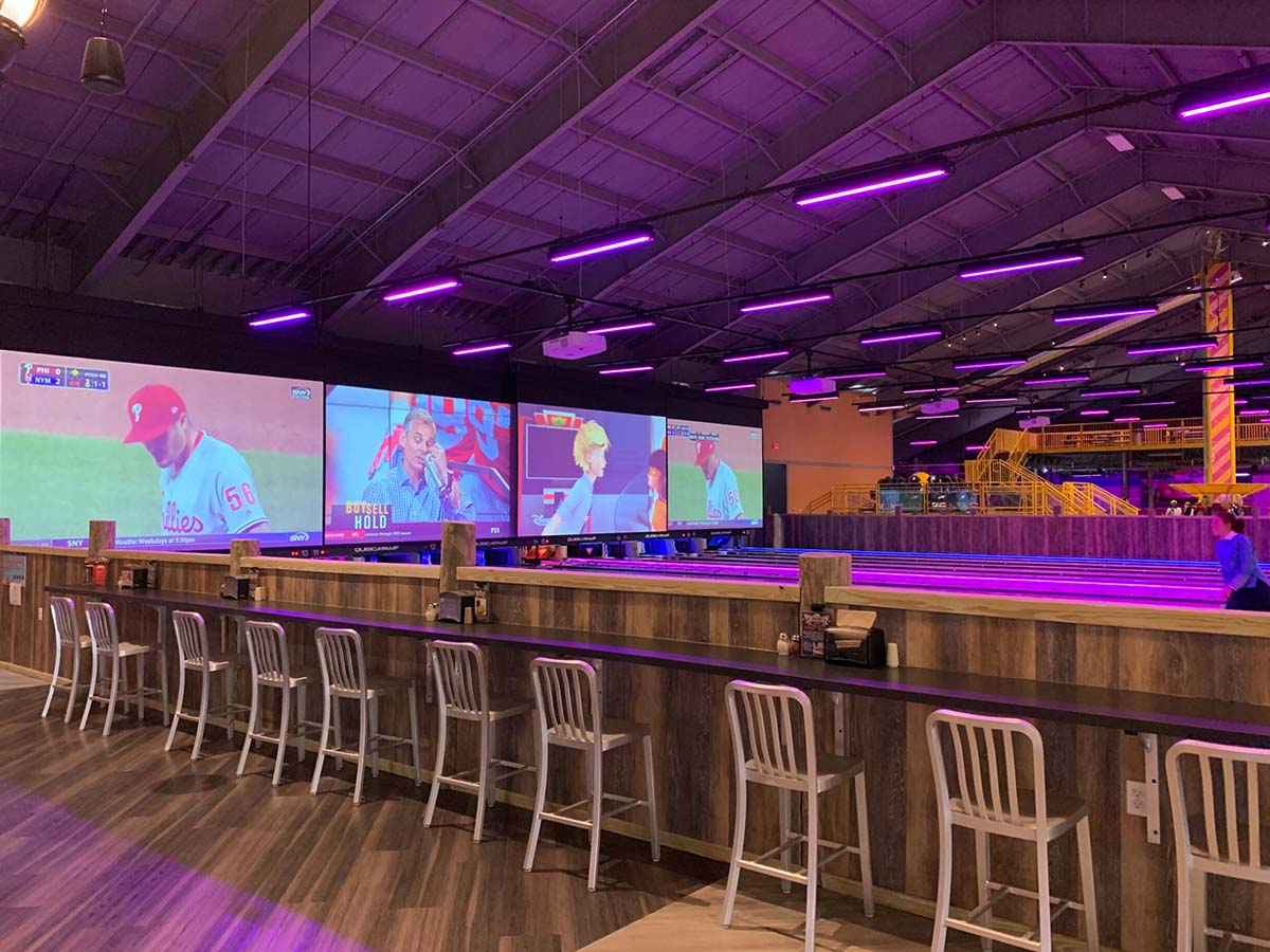 Projection screens and Versalamp fixtures over bowling lanes