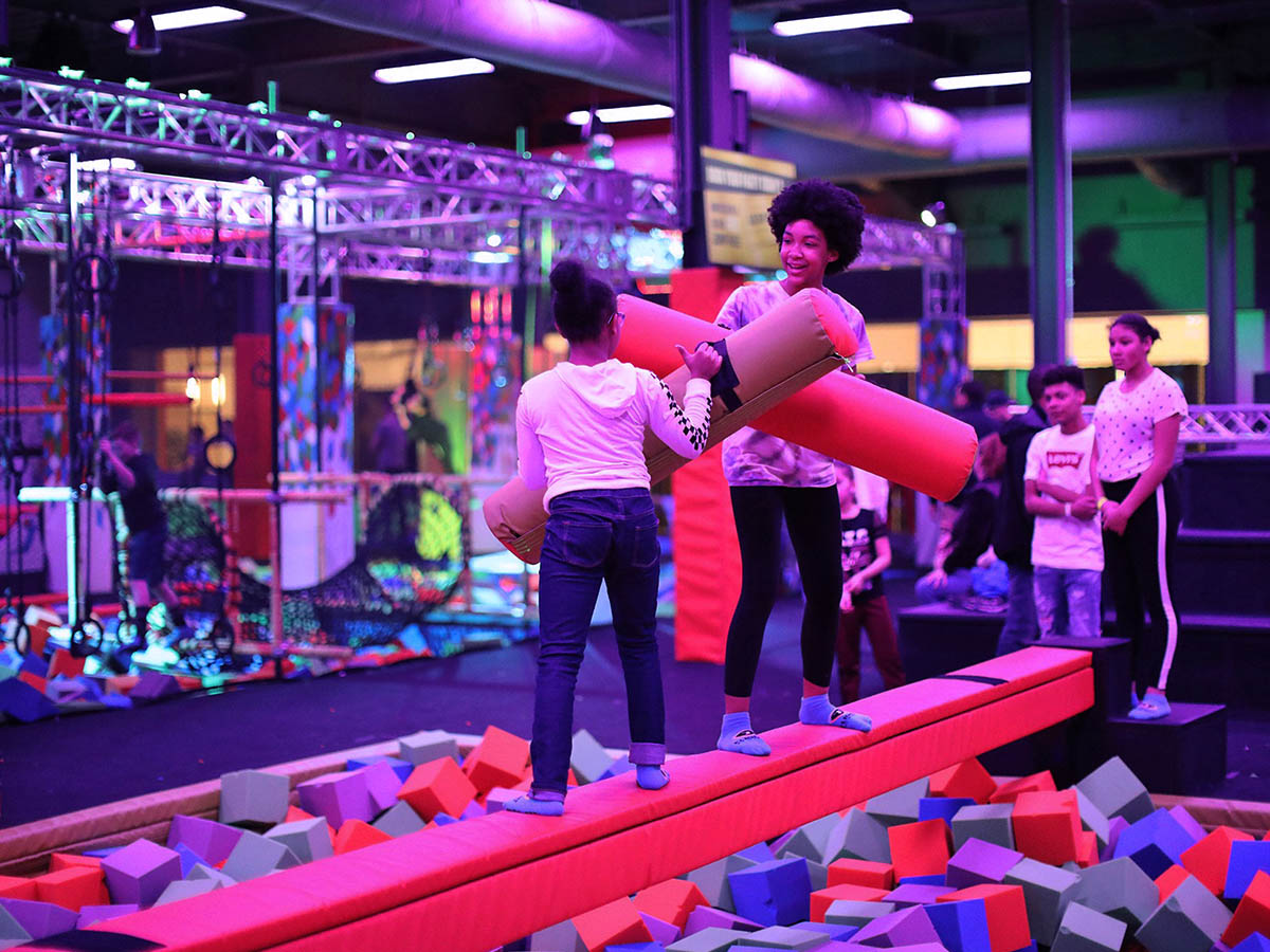 Guests playing in a foam pit with UV lighting